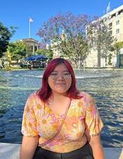 Lizbeth Vargas-Martinez sitting in front of fountain.